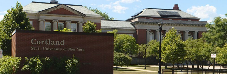 SUNY-Cortland A picture of some Greek revival style buildings with a SUNY Cortland sign partially blocking the view.